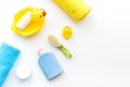 Bath accessories for kids. Yellow rubber duck, soap, sponge, brushes, towel on white background top view copyspace Royalty Free Stock Photo