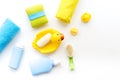 Bath accessories for kids. Yellow rubber duck, soap, sponge, brushes, towel on white background top view copyspace Royalty Free Stock Photo