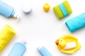 Bath accessories for kids. Yellow rubber duck, soap, sponge, brushes, towel on white background top view copyspace Royalty Free Stock Photo