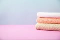 Bath accessories - towels folded, stacked on a light, bright blue and pink background The concept of caring for yourself, your bod Royalty Free Stock Photo