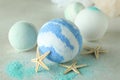 Bath balls and starfishes on white textured table Royalty Free Stock Photo