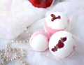 Bath balls, towel, pearl and red rose on white background