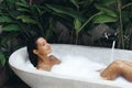 Bath and Body Care Day of Spa Woman in Bathtub Full of Foam, Tropical Relax Royalty Free Stock Photo