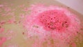 Bath bomb dissolves in water Royalty Free Stock Photo