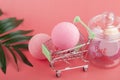 Bath bomb in the shopping cart, body care cosmetics, pink salt