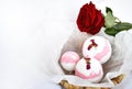 Bath bombs,in basket and red rose on white background. Royalty Free Stock Photo