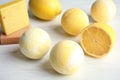 Bath bombs and lemon on white background