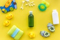 bath cosmetic set for kids, towel and toys on yellow background top view pattern Royalty Free Stock Photo