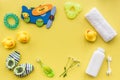 Bath cosmetic set for kids, towel and toys yellow background top view space for text Royalty Free Stock Photo