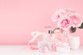 Bath cosmetics products, romantic bouquet and accessories in elegant pastel pink color - massage rose oil, bath salt, cream, soap.