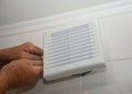 Bath fan repair, installation. Handyman installing new bath vent fan, ventilation system in the house bathroom