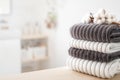 Bath fresh towels pile soft textile cotton body care neatly folded white gray laundry flower shelf. Blurred background