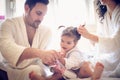 After bath we need to take care for our little girl. Happy parents. Royalty Free Stock Photo