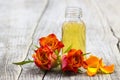 Bath oil and orange rose on ooden background Royalty Free Stock Photo