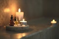 bath oils on plinth, candles flickering slightly blurred Royalty Free Stock Photo