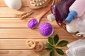 Bath products and essences in basket on wooden table top Royalty Free Stock Photo
