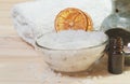 Bath salt in bowl, towel, essential oil in glass bottle Royalty Free Stock Photo