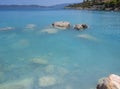 Bath in the sea with tourists and vacationers at the thermal healing hot springs of the Greek resort of Methana on the Peloponnese