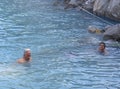 Bath in the sea with tourists and vacationers at the thermal healing hot springs of the Greek resort of Methana on the Peloponnese