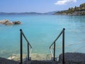 Bath in the sea with tourists and vacationers at the thermal healing hot springs of the Greek resort of Methana on the Peloponnese