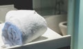 Bath towel rolled on a sink in a bathroom Royalty Free Stock Photo