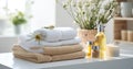 Bath towels with beauty treatment products setting in spa center in white room, Royalty Free Stock Photo