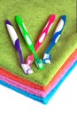 Bath towels of different colors and toothbrushes isolated Royalty Free Stock Photo