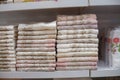 Bath towels on shelf in market, sale cotton towels, stack plain cotton towels, a shelf in the home row of the market