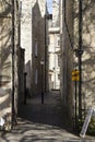 Long shadows cast on alleyway in courtyard.