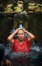 A Bather at the tirta empul fountains in bali 2