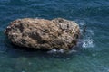 Bathers jump of a rock island off the beach at Konyaalti Plaji in Antalya in Turkey.