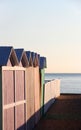 Bathing boxes and fence at sunset, empty Royalty Free Stock Photo