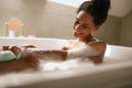 Bathing in comfort, happy woman in jacuzzi with sponge, leisure and fun Royalty Free Stock Photo