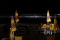 Bathing establishments with deck chairs and umbrellas on the beach at night Royalty Free Stock Photo