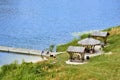 Bathing jetty on a lake in Masuria with shelters and bathers, aerial view