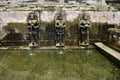 Bathing temple figures or holy water fountain of Goa Gajah or Elephant Cave significant Hindu archaeological site for travelers Royalty Free Stock Photo