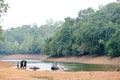 Bathing time for elephant in a lake with gadman