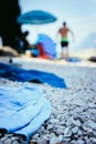 Bathing towel on the beach, other people in blurry background