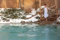 Bathing young woman in a frozen lake after sauna Royalty Free Stock Photo