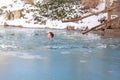 bathing young woman in a frozen lake after sauna Royalty Free Stock Photo