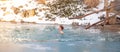 Bathing young woman in a frozen lake after sauna Royalty Free Stock Photo