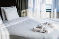 Bathrobe and Slippers are on the bed in the hotel room Royalty Free Stock Photo