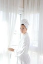 Bathrobe woman sunny window white curtains