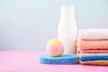 Bathroom accessories - towels and shampoos,bath foam, cream on a light, bright blue and pink background The concept of caring for Royalty Free Stock Photo