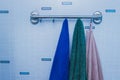 Bathroom. background for an inscription. Three towels are hanging on the background of the blue wall Royalty Free Stock Photo