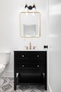 A bathroom with a black cabinet and pattern tiled floor. Royalty Free Stock Photo