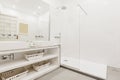 Bathroom with built-in vanity unit with white porcelain sink, wicker baskets, Royalty Free Stock Photo