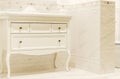 Bathroom cabinet. dressing table in classic white style. interior is lined with beige tiles Royalty Free Stock Photo