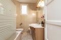 Bathroom with cherry wood cabinet with integrated mirror and shower cabin Royalty Free Stock Photo