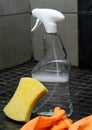 Bathroom cleaning equipment with spray bottle, gloves and a sponge on tile floor Royalty Free Stock Photo